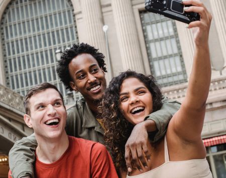 Friends taking selfie in city